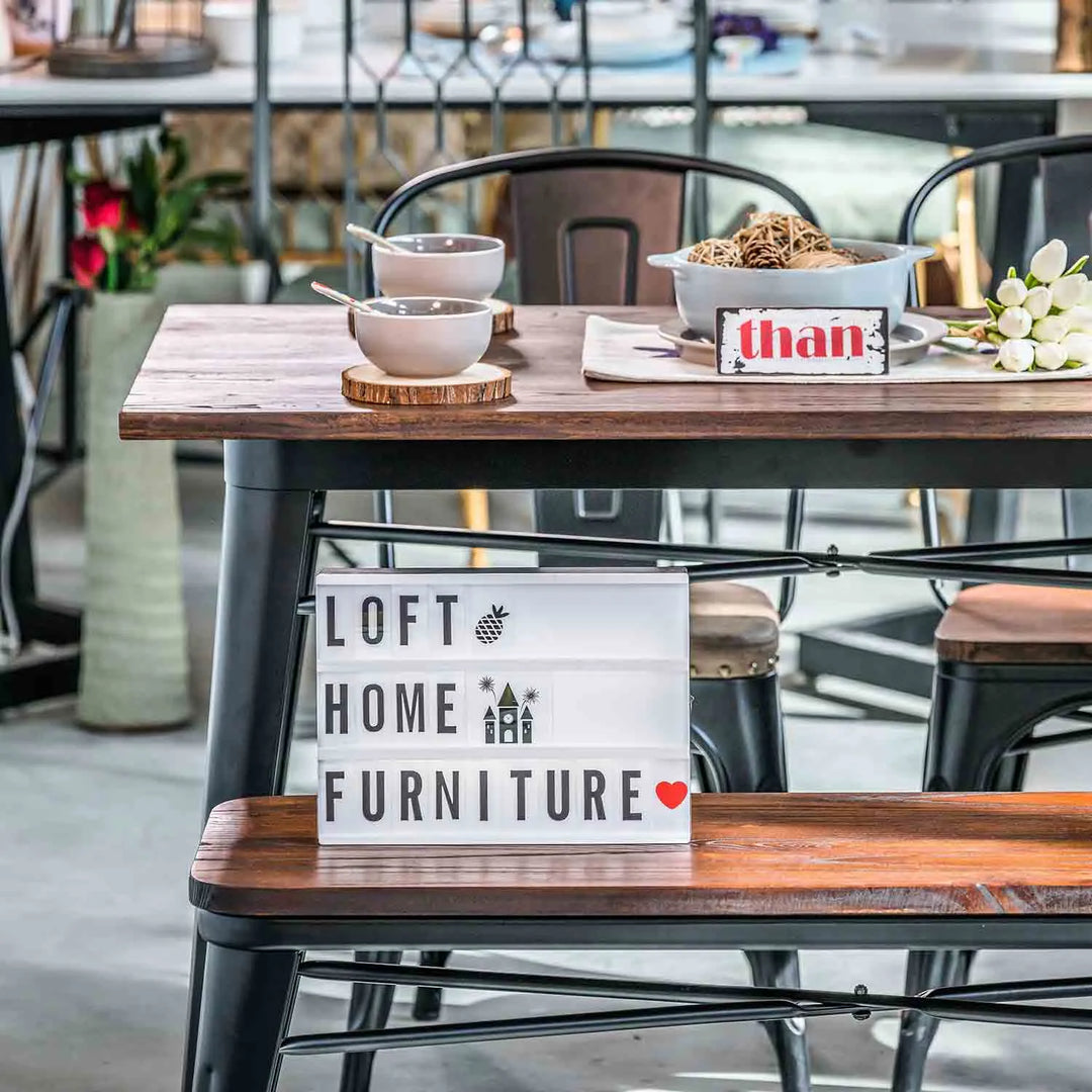 Featured in Loft Home's new arrivals collection: Stylish dining setup with a wooden table, metal chairs, and a decorative sign reading 'Loft Home Furniture'.