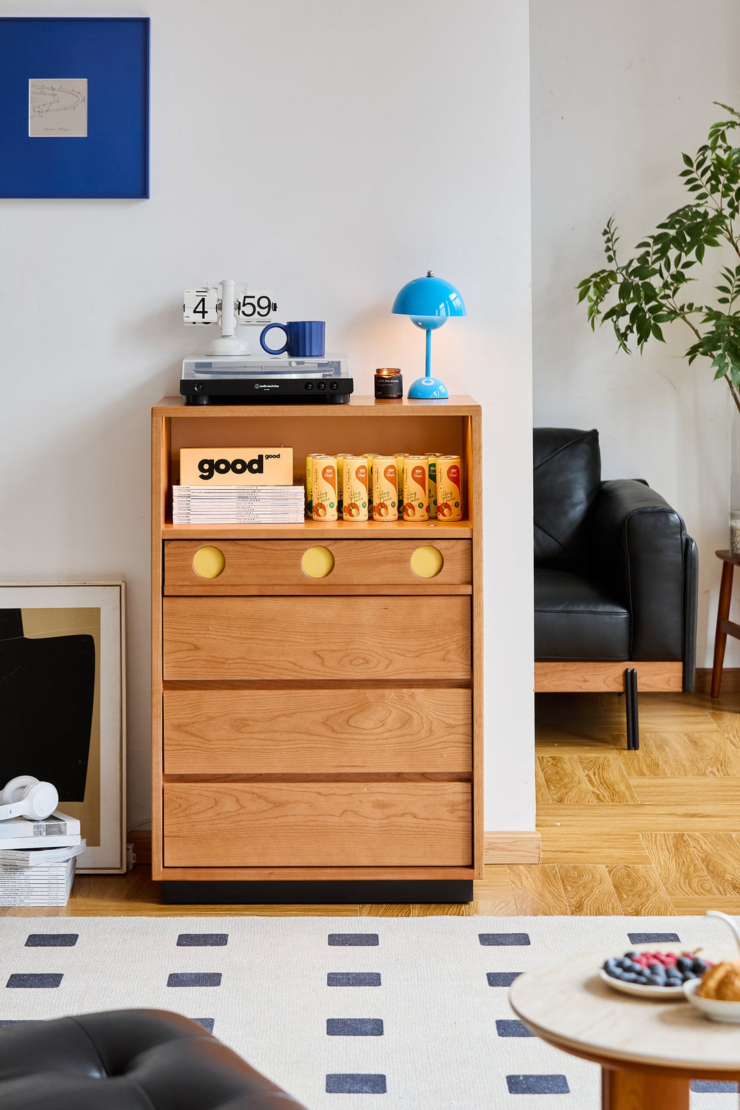 Wooden chest of drawers with books and a blue lamp in a living room setting. Loft Home chest of drawers collection cover picture.