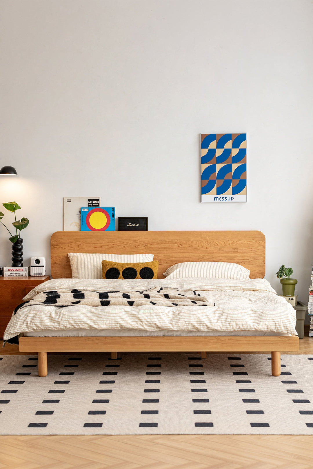 Minimalist oak wood bed frame with rounded headboard, enhancing a modern bedroom with warm tones.