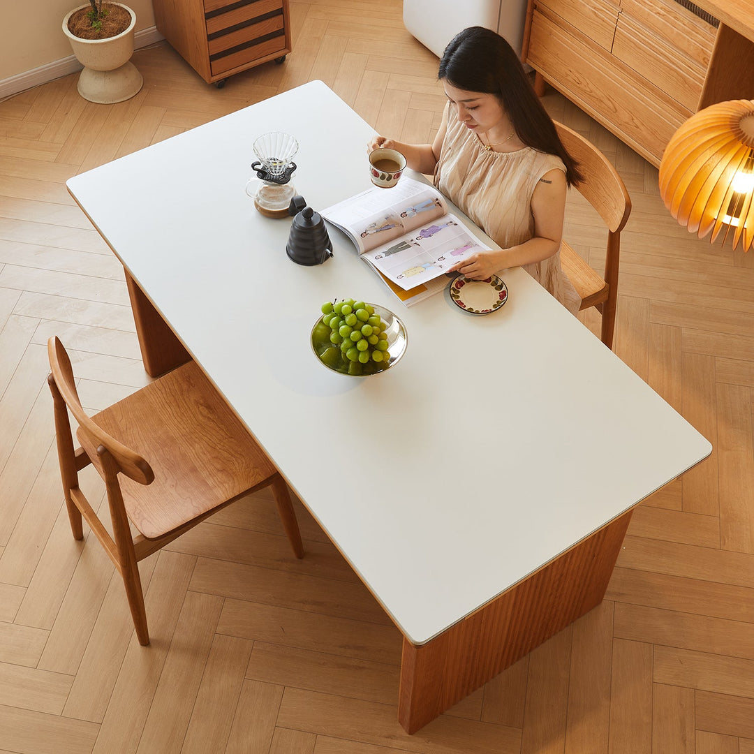 LoftHome sintered stone dining table with sleek white tabletop and solid wood base, elegantly styled for modern dining spaces, adding durability and minimalist charm.