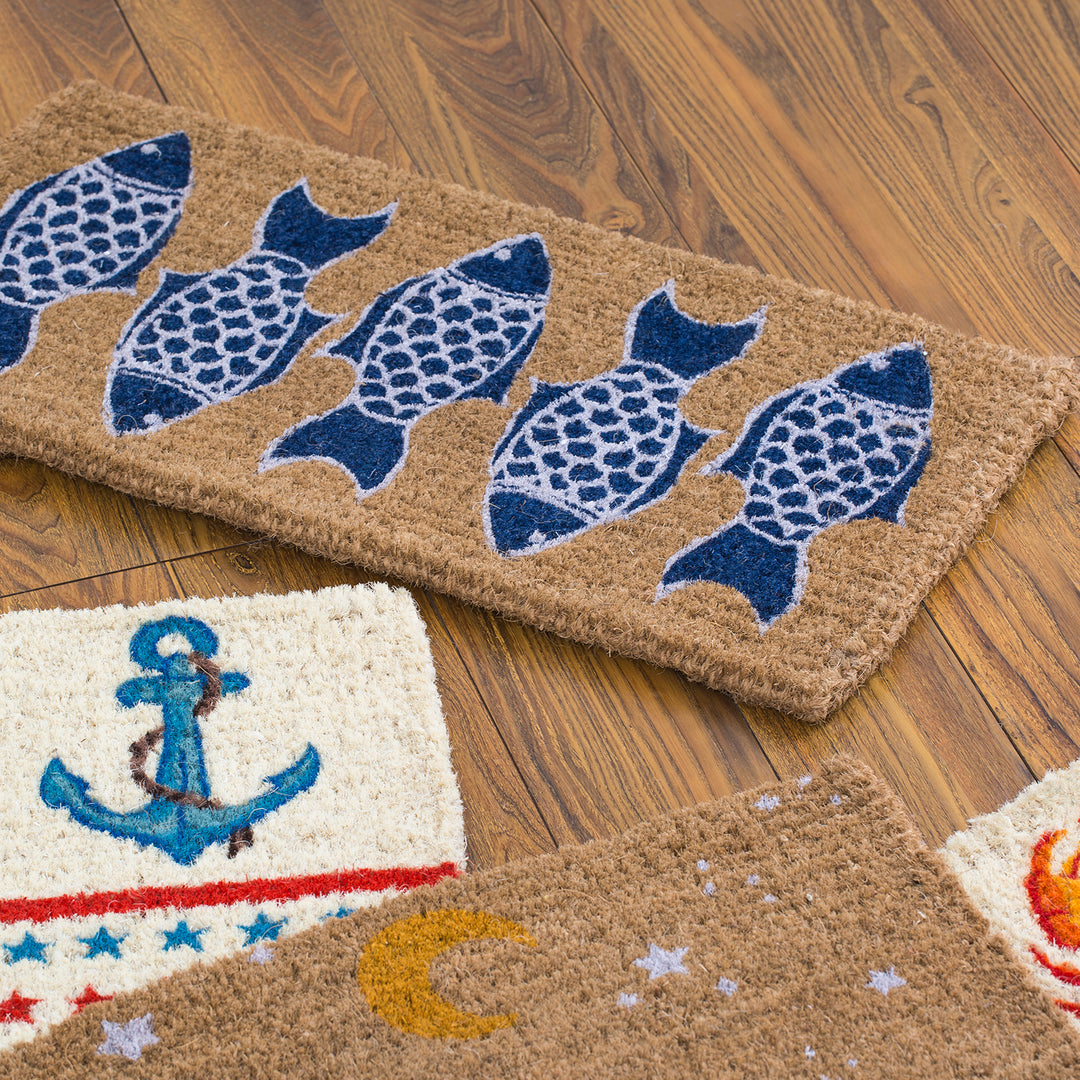 Three nautical-themed doormats featuring a pattern of blue fish, an anchor, and celestial designs, placed on a wooden floor.