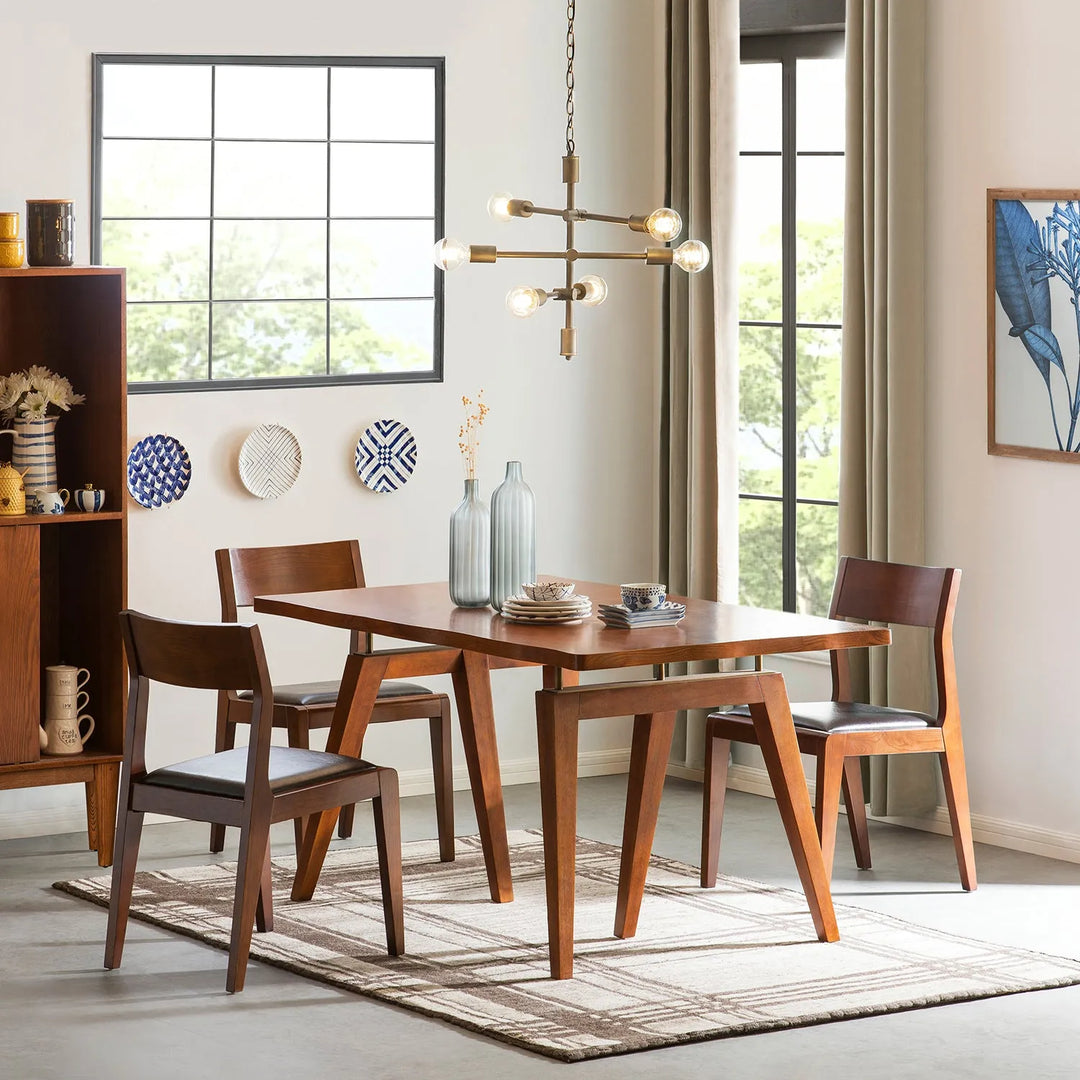 Modern wooden dining table set with chairs in a bright room, featuring a stylish pendant light and decorative wall plates, linking to Loft Home's tables by size collection.