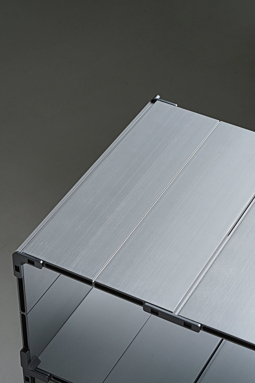 Aluminum metal table on a dark gray background, showcasing loft home Singapore's featured products for metal tables.