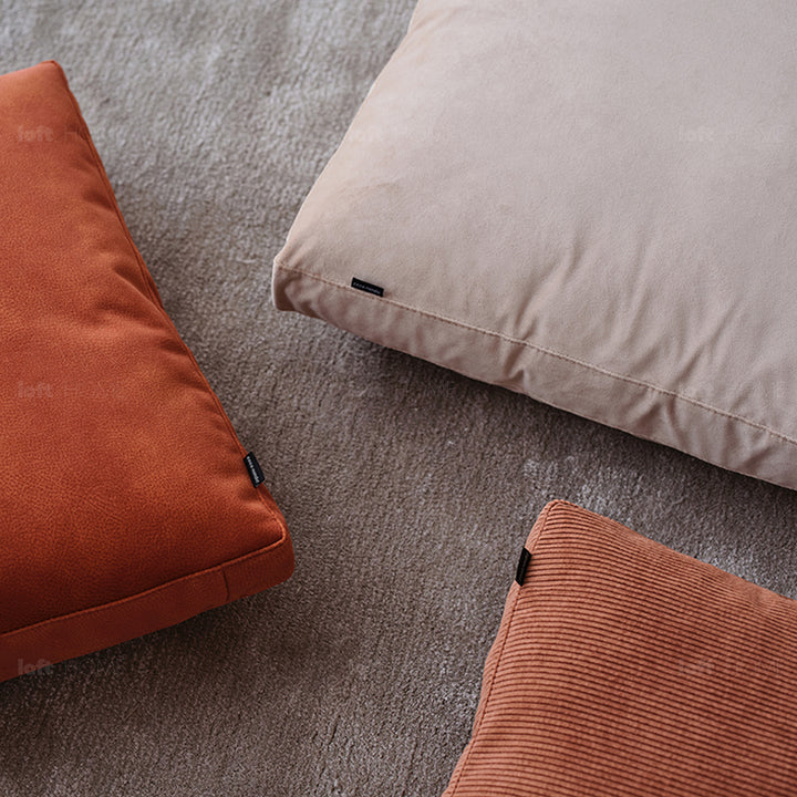 Minimalist fabric sofa pillow corduroy orange color swatches.