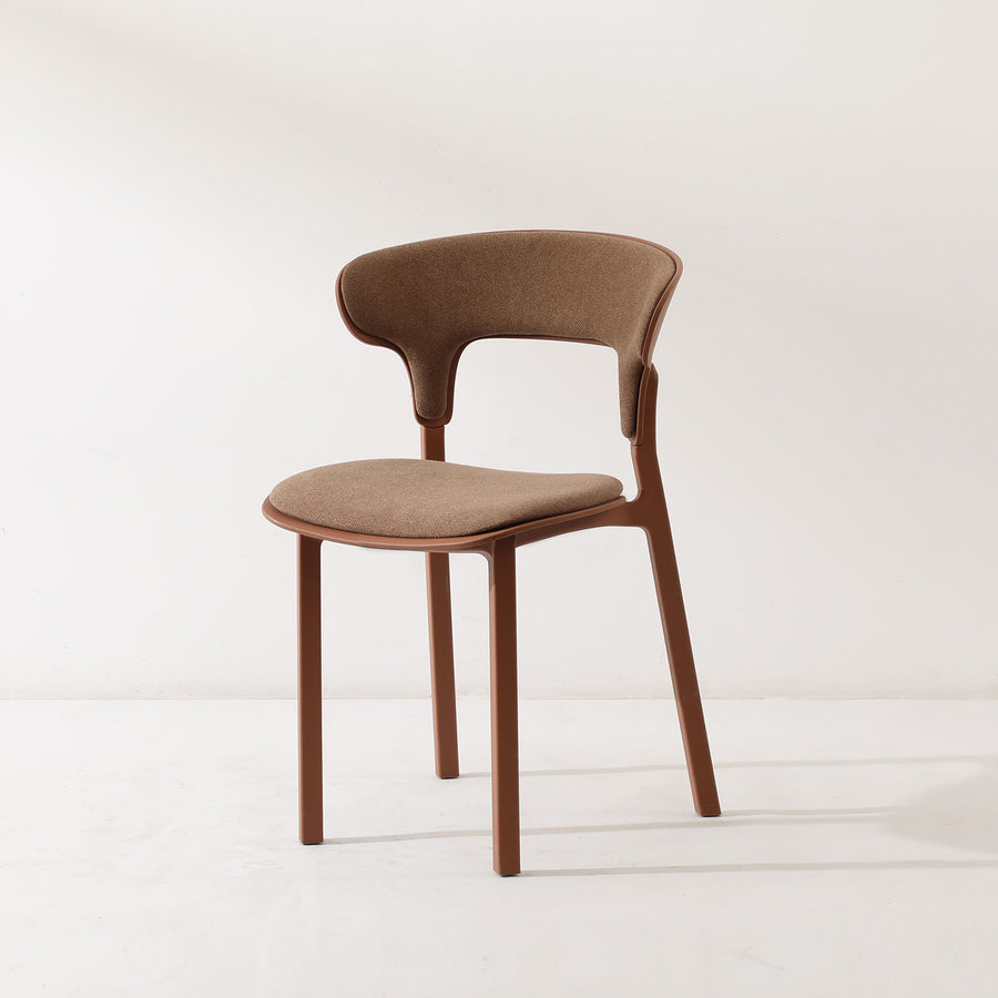 Contemporary fabric plastic dining chair hug in white background.