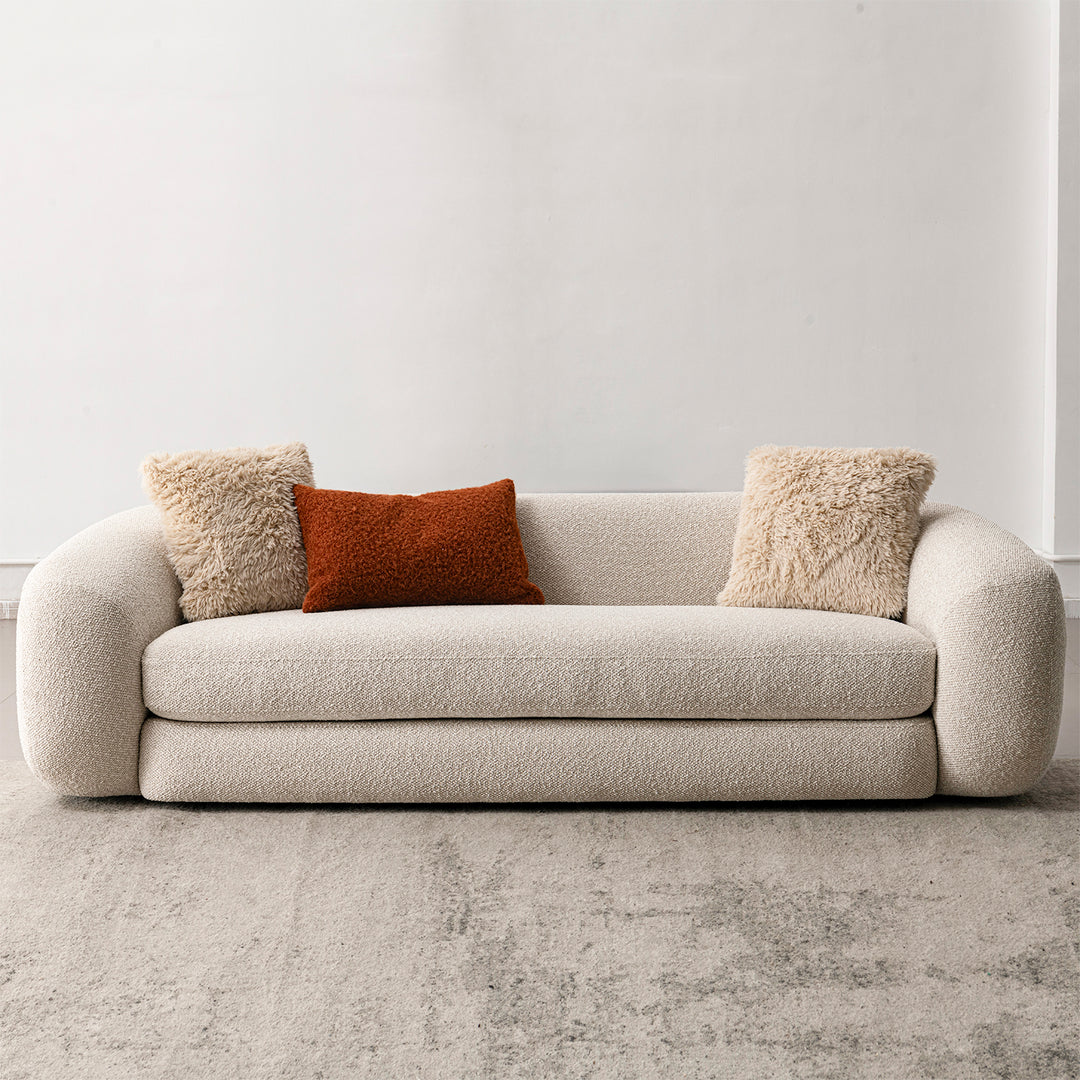 Cream boucle fabric 3 seater sofa curly in panoramic view.