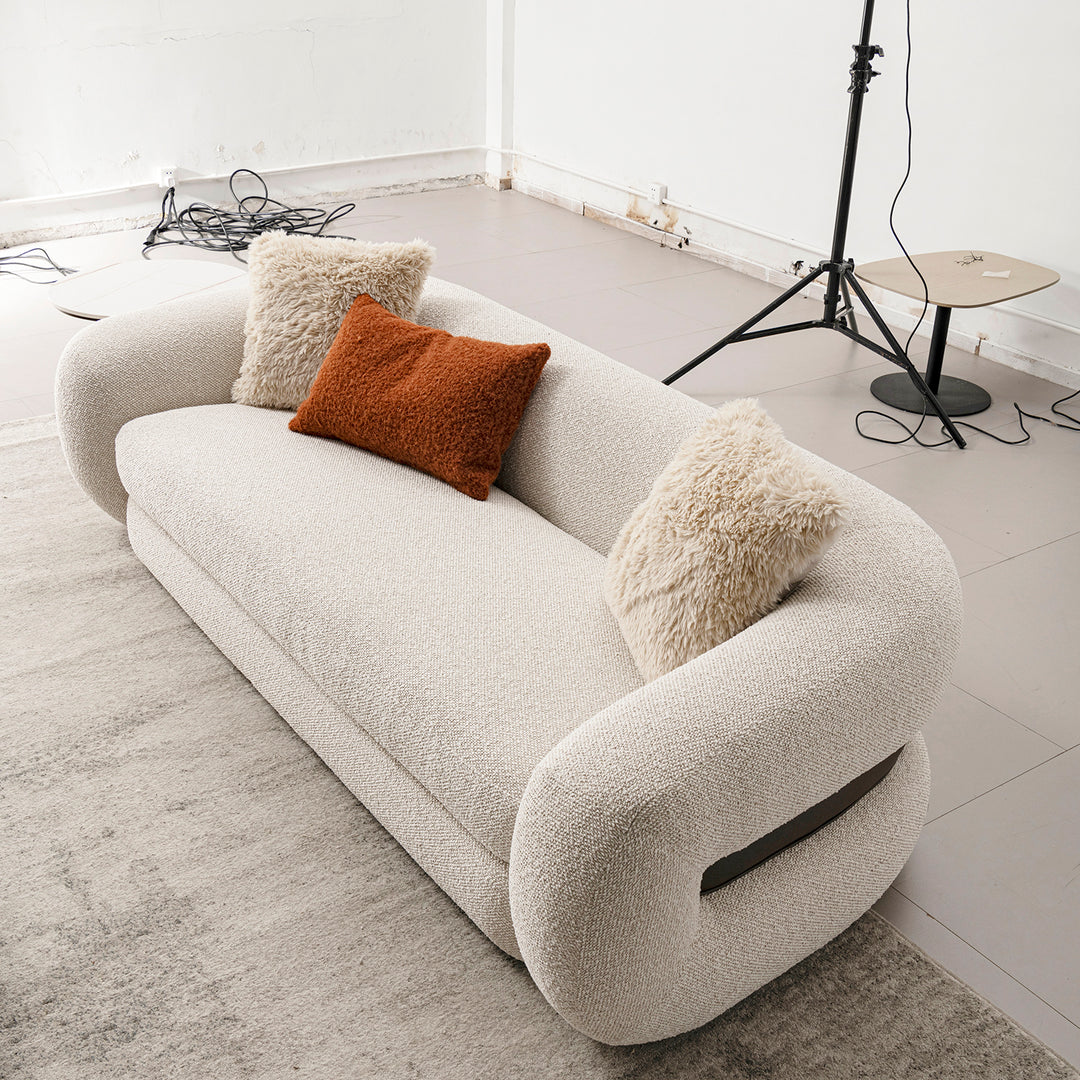 Cream boucle fabric 3 seater sofa curly in details.