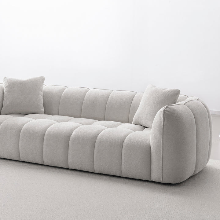 Cream mixed weave fabric 4 seater sofa puddy in details.