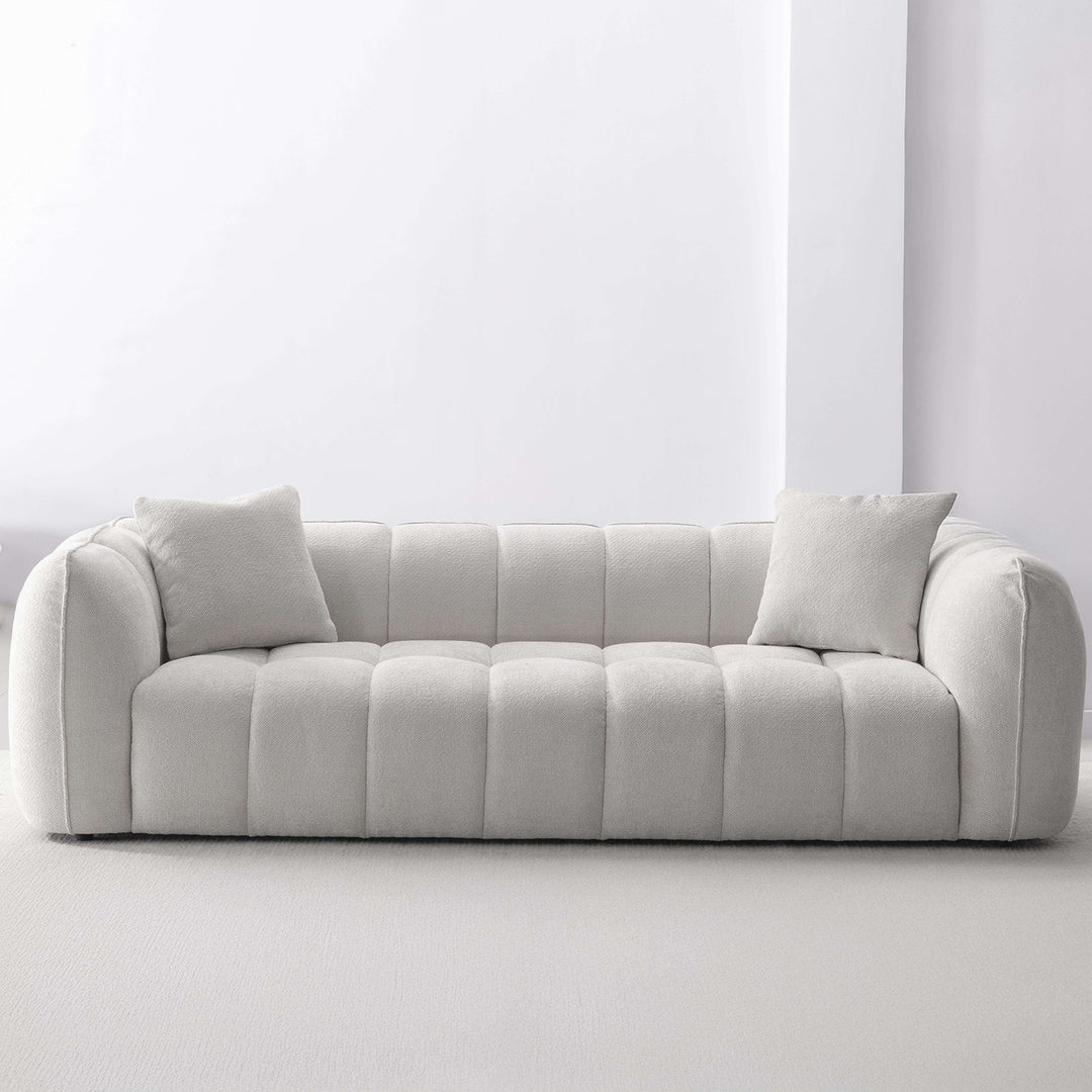 Cream mixed weave fabric 4 seater sofa puddy with context.