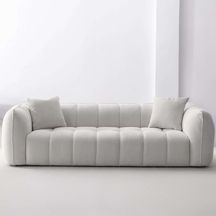 Cream mixed weave fabric 4 seater sofa puddy with context.