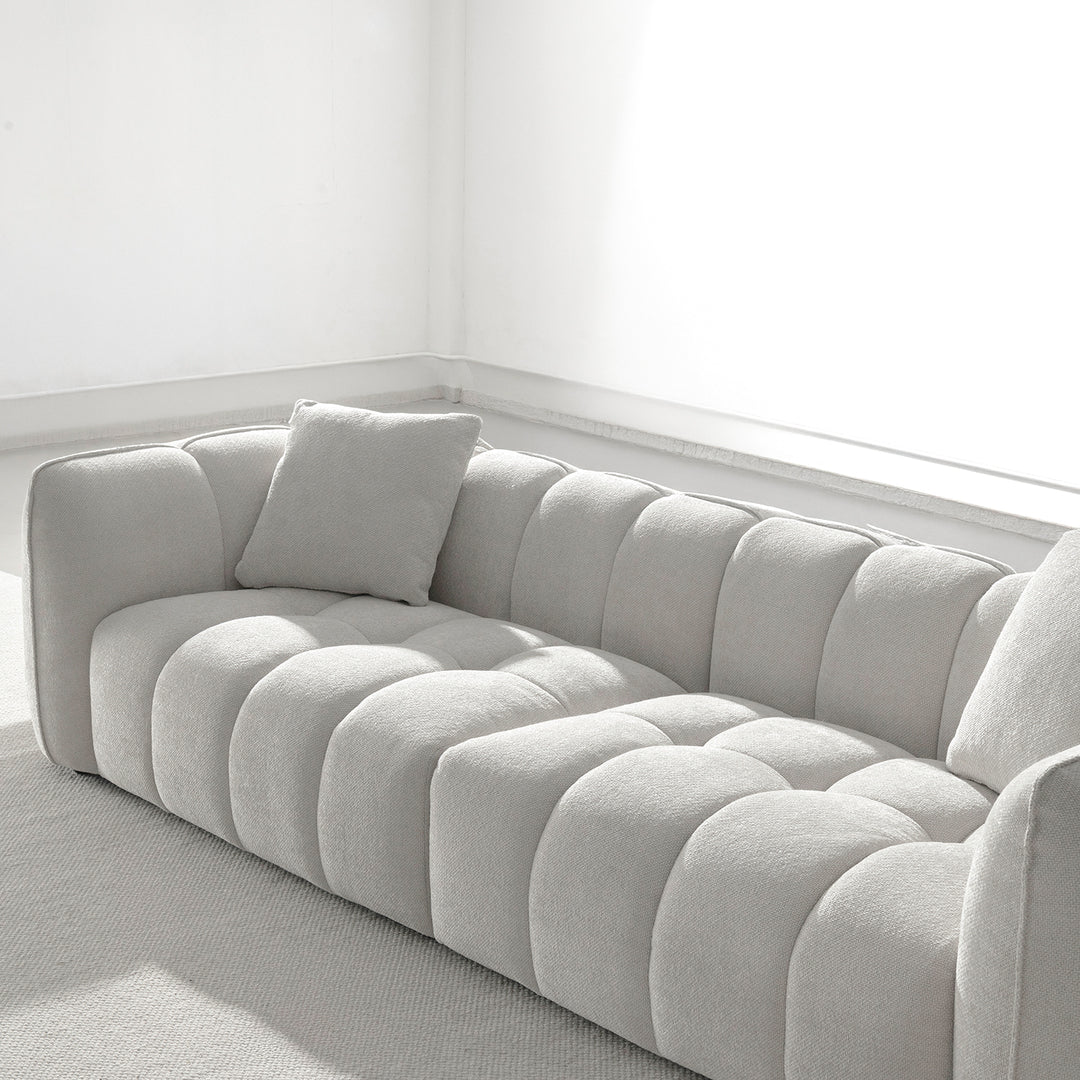 Cream mixed weave fabric 4 seater sofa puddy in close up details.