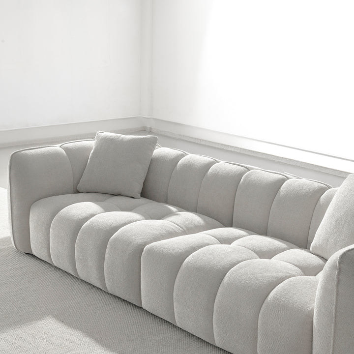 Cream mixed weave fabric 4 seater sofa puddy in close up details.