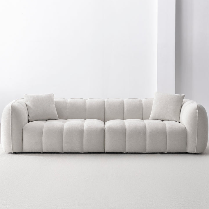 Cream mixed weave fabric 4 seater sofa puddy in still life.