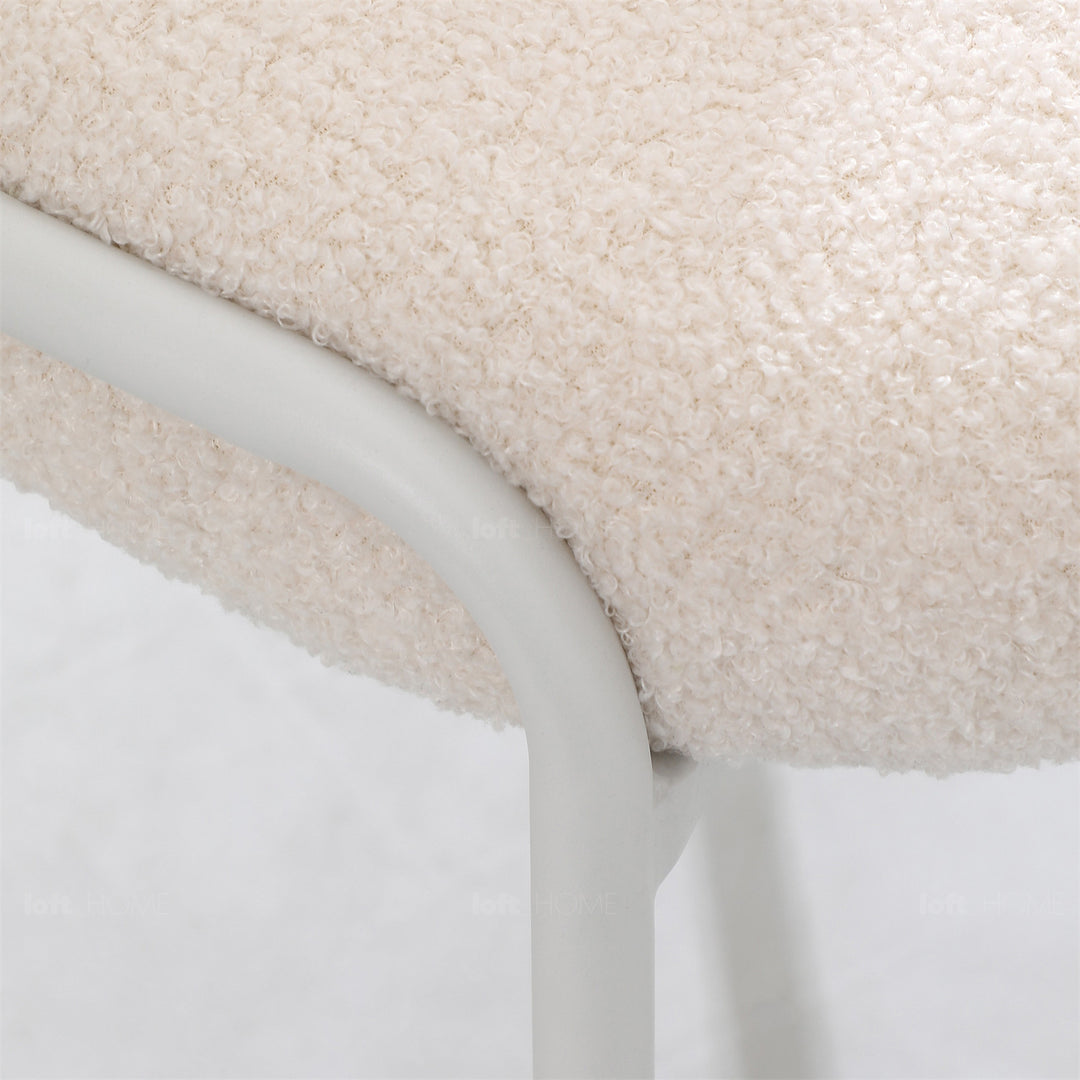 Cream boucle dining chair pavlova ii in close up details.