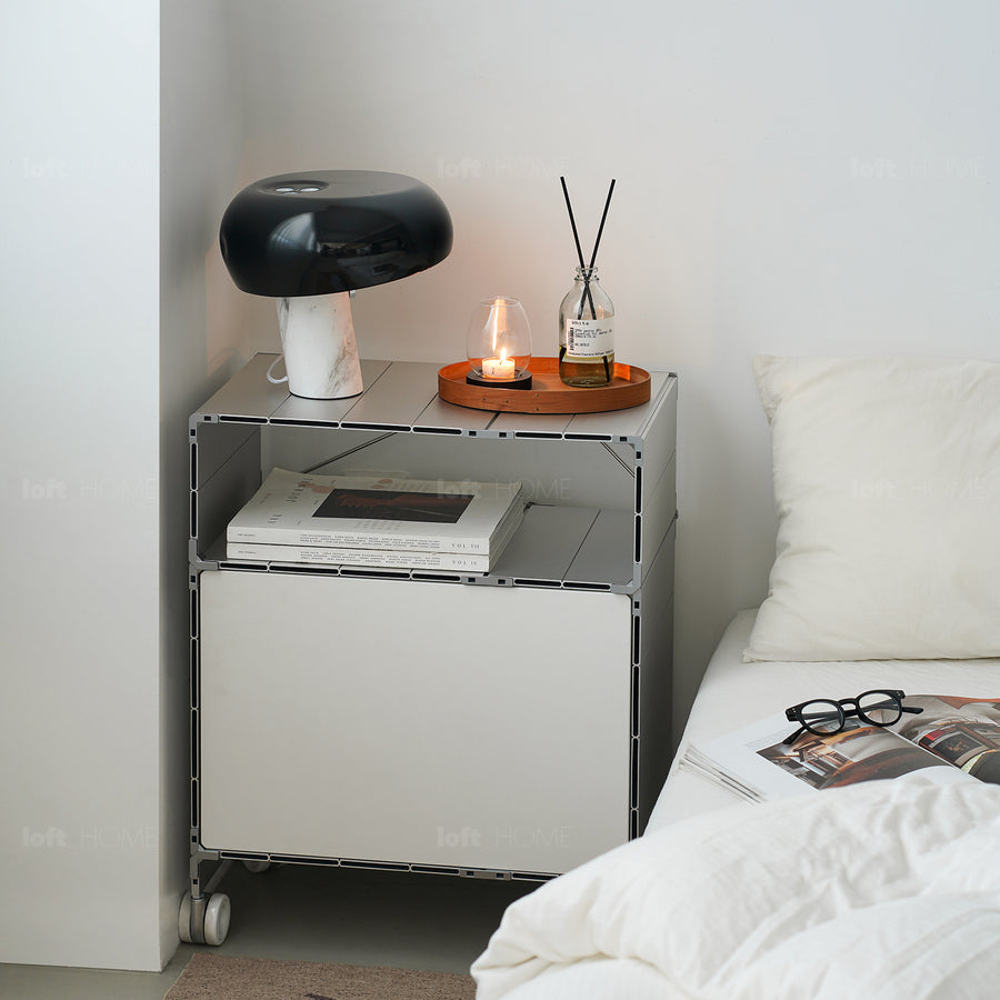 Industrial aluminium wheeled trolley side table cube in still life.