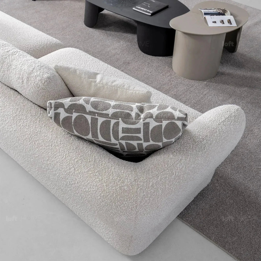 Modern boucle fabric 4 seater sofa couch in panoramic view.