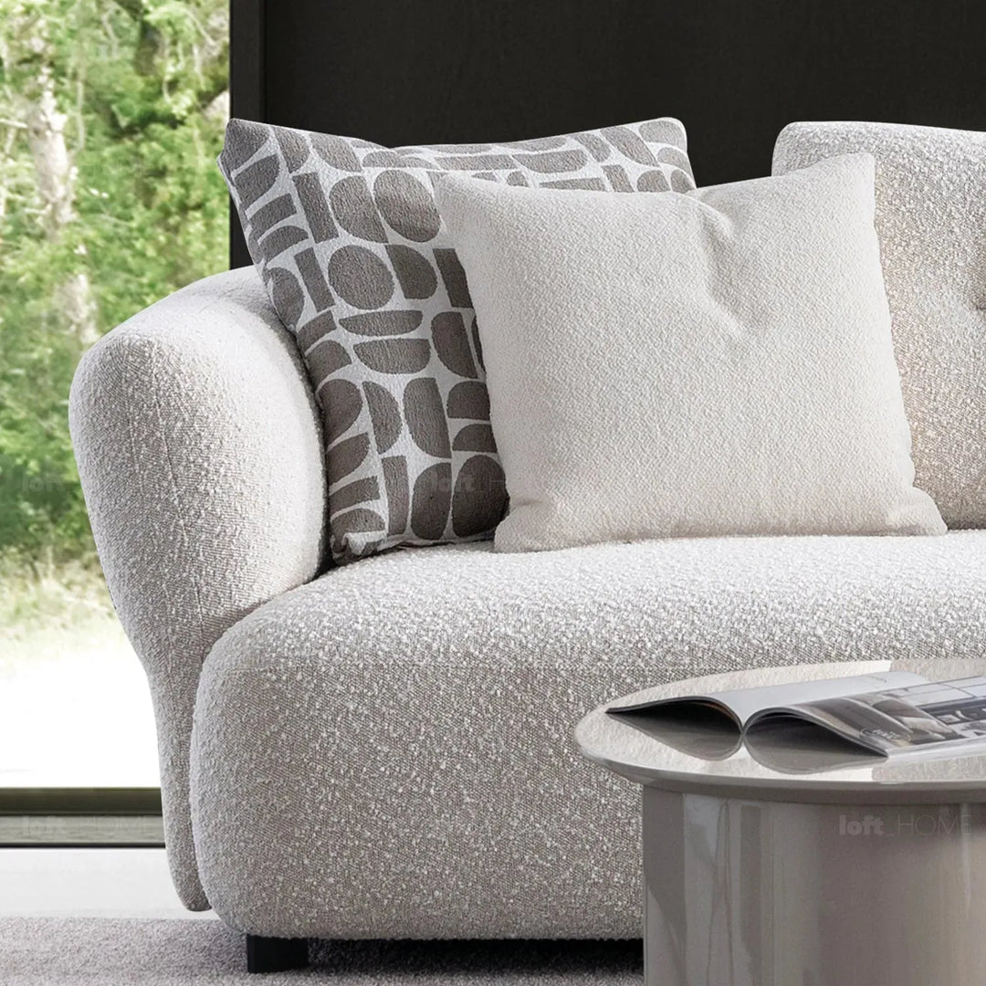 Modern boucle fabric 4 seater sofa couch in close up details.