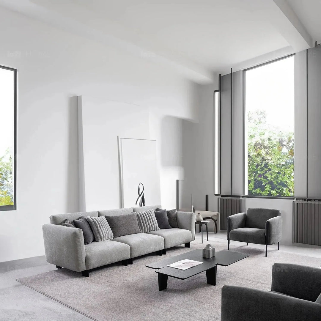 Modern boucle fabric bendable armrest 4 seater sofa pristine in panoramic view.