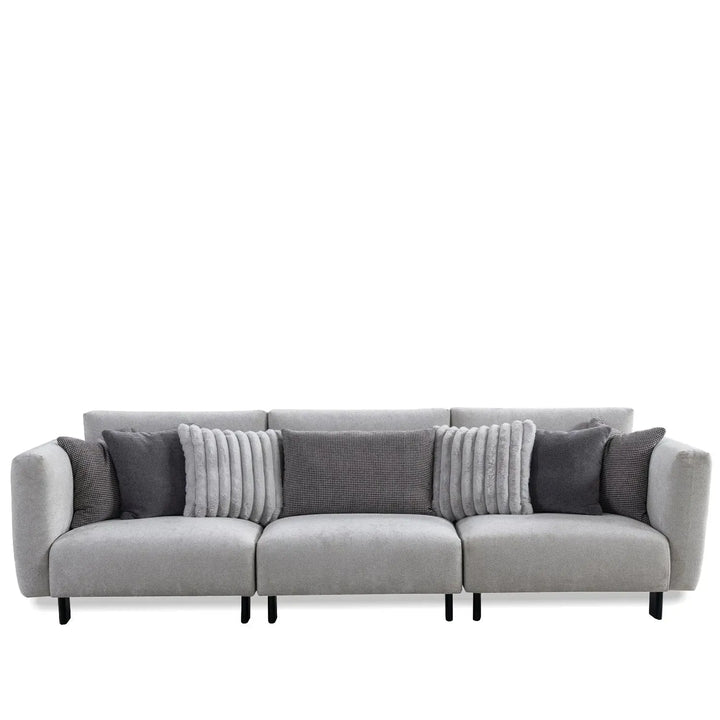 Modern boucle fabric bendable armrest 4 seater sofa pristine in white background.