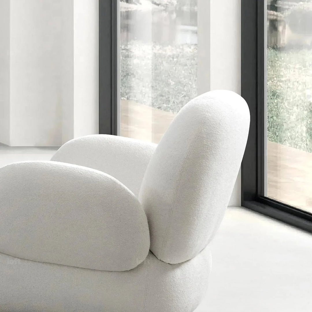 Cream boucle fabric revolving 1 seater sofa boucle in panoramic view.