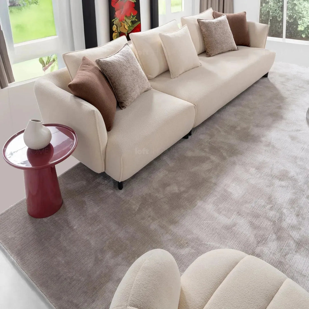 Cream sherpa fabric revolving 1 seater sofa gown in panoramic view.