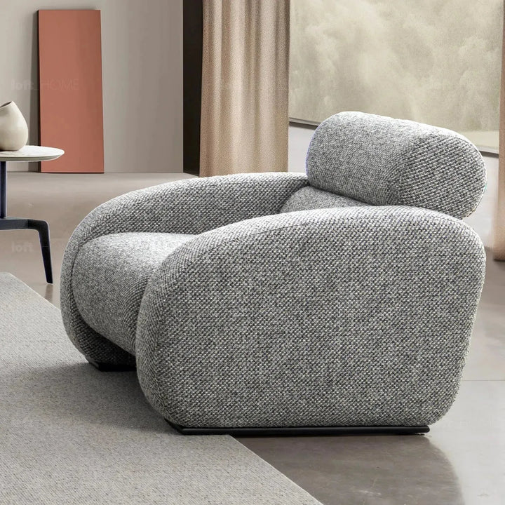 Modern mixed weave fabric 1 seater sofa monolithe in panoramic view.