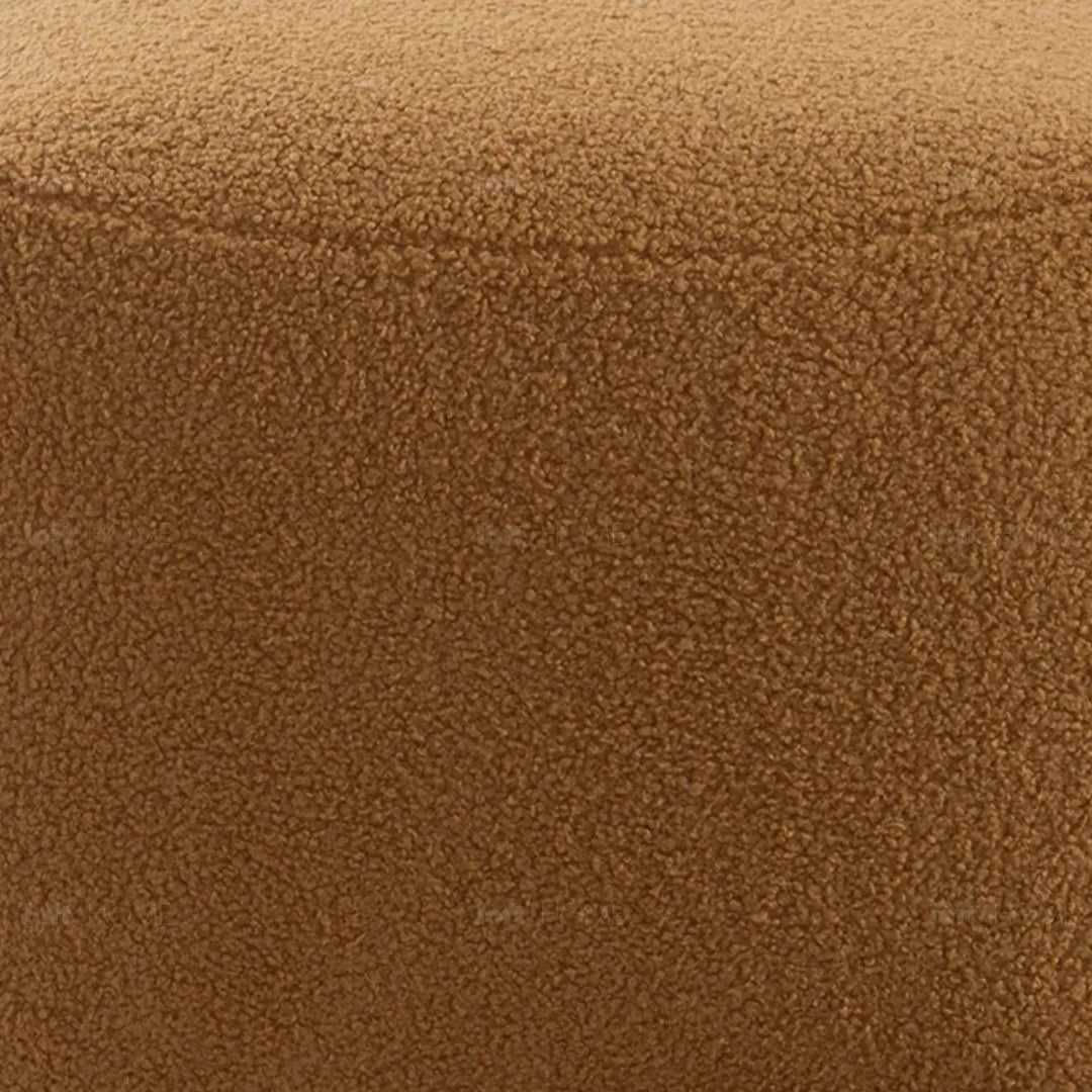 Cream sherpa fabric ottoman saffron in panoramic view.