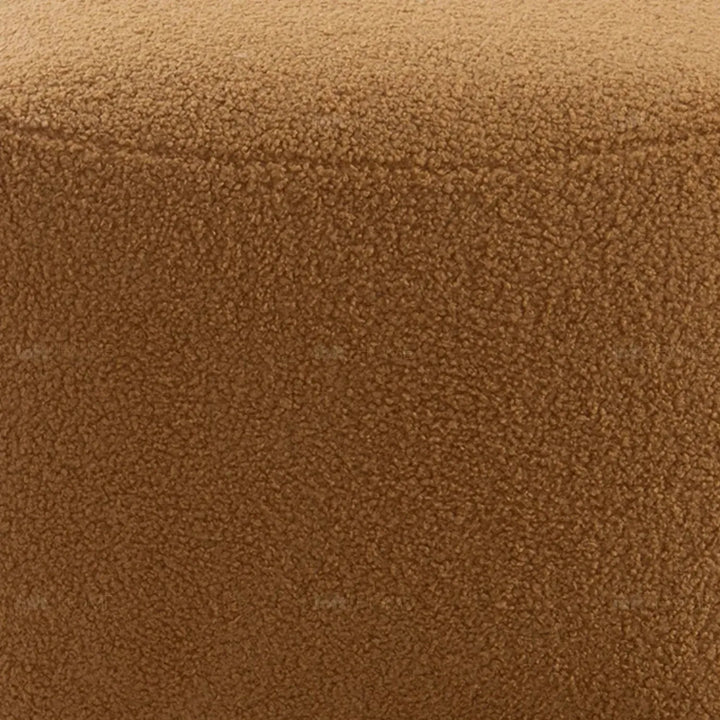 Cream sherpa fabric ottoman saffron in panoramic view.