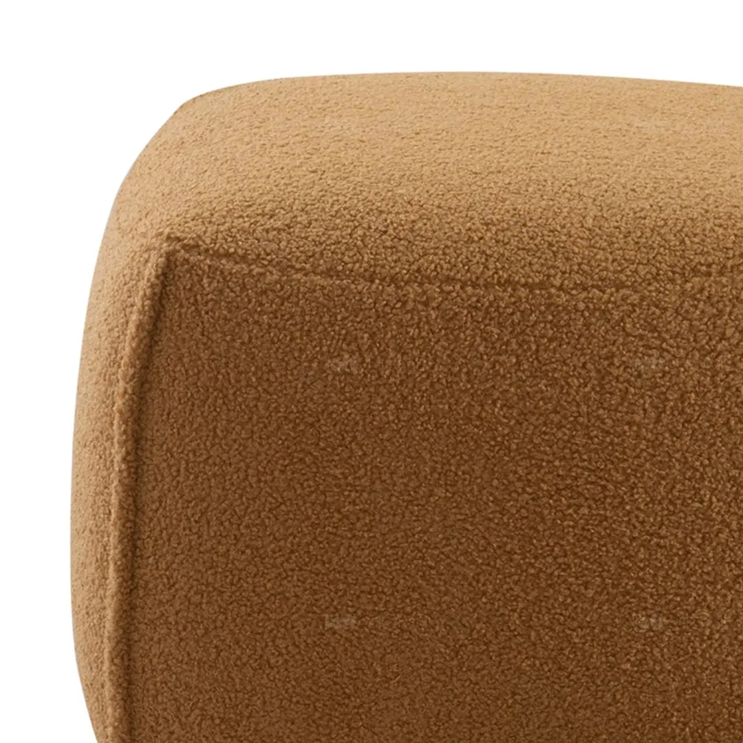 Cream sherpa fabric ottoman saffron with context.