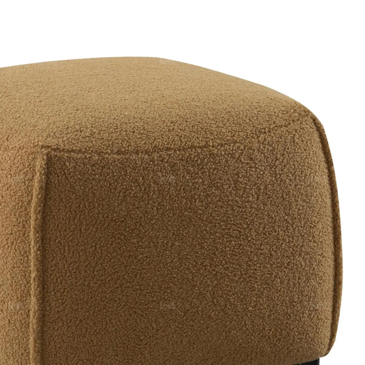 Cream sherpa fabric ottoman saffron in details.