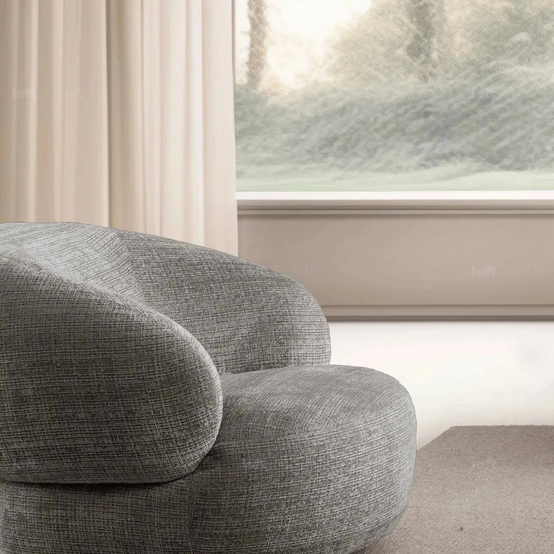 Cream mixed weave fabric revolving 1 seater sofa criet in close up details.