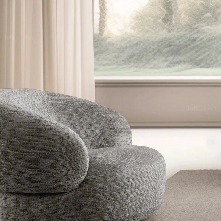 Cream mixed weave fabric revolving 1 seater sofa criet in close up details.