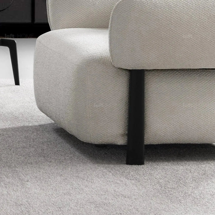 Cream mixed weave fabric 1 seater sofa callee in panoramic view.