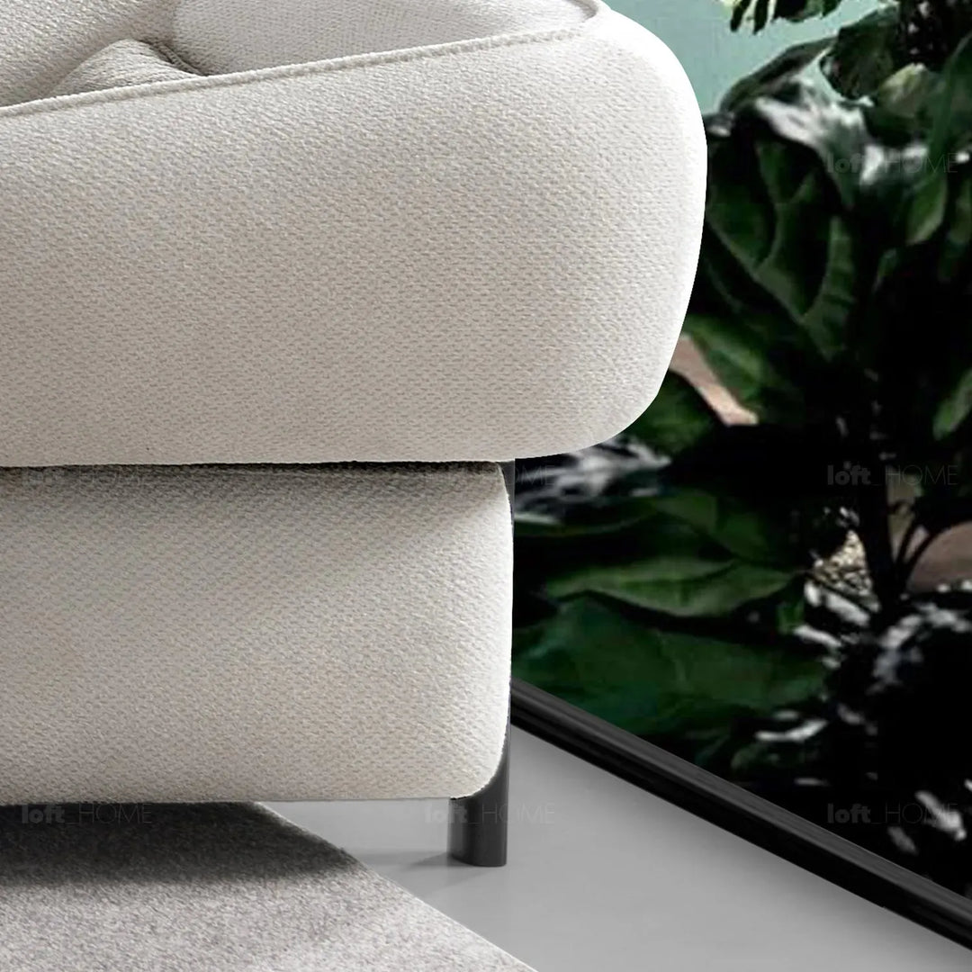 Cream mixed weave fabric 1 seater sofa callee in close up details.