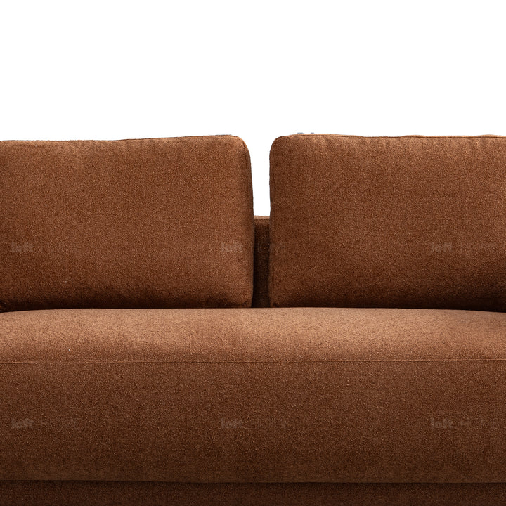 Modern boucle fabric 2 seater sofa rusty in details.