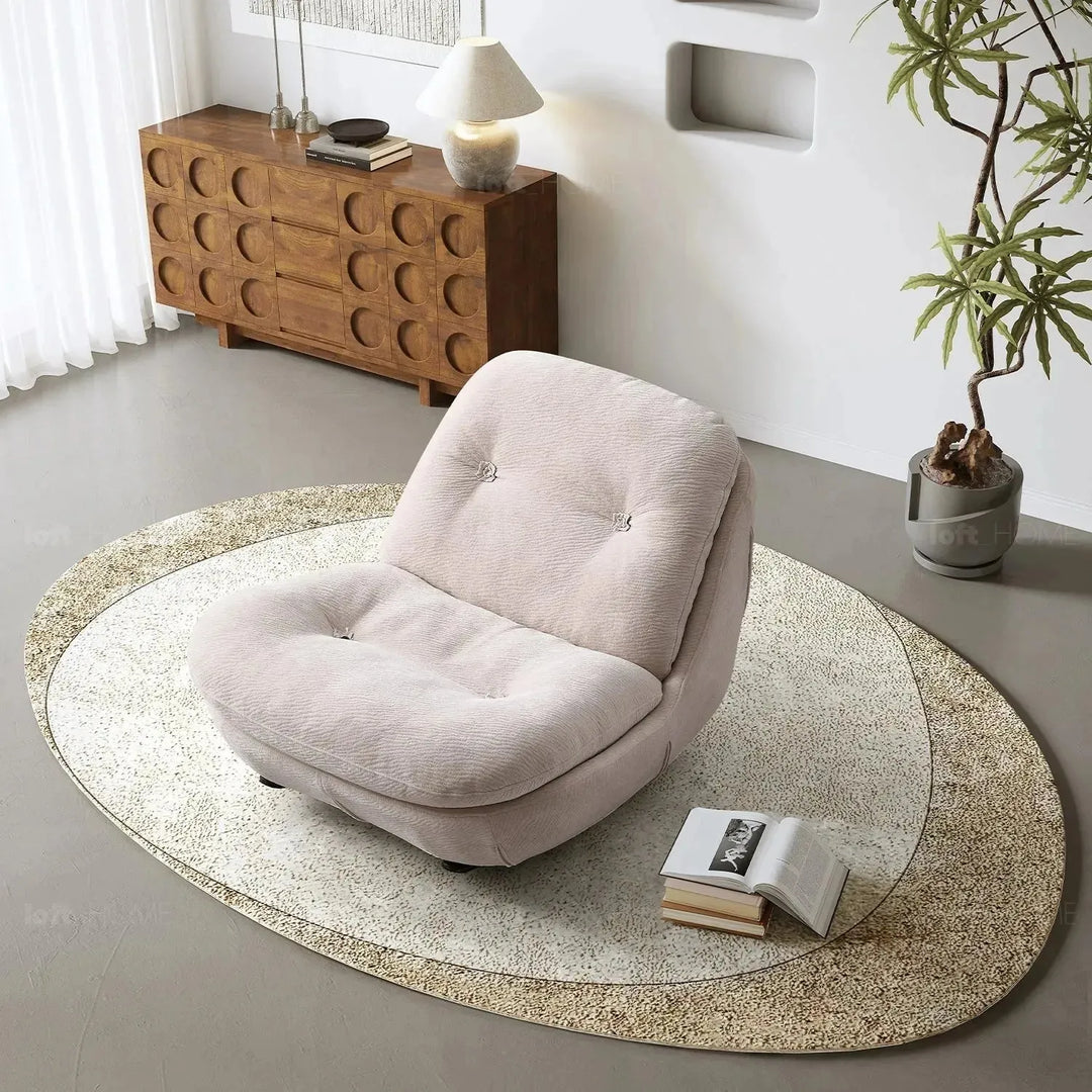 Cream chenille velvet fabric rocking 1 seater sofa nebula in panoramic view.