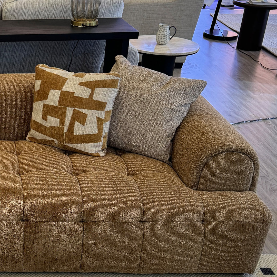 Modern mixed weave fabric 3 seater sofa puff in still life.