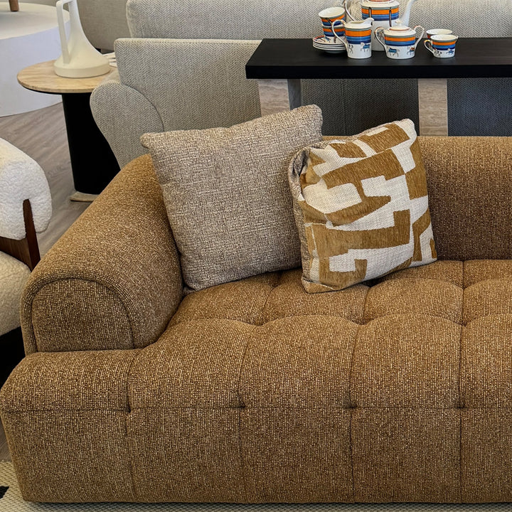 Modern mixed weave fabric 3 seater sofa puff in panoramic view.