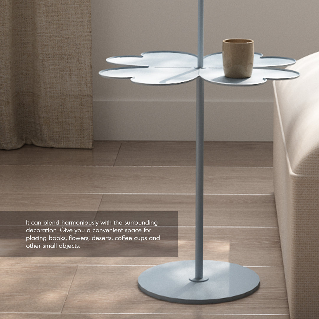 Contemporary steel side table flower with context.