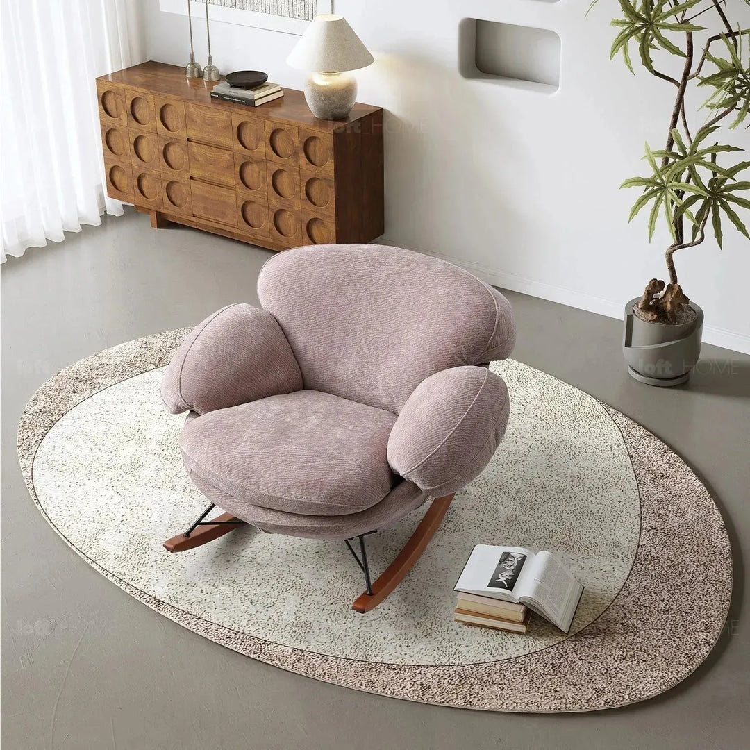 Cream teddy fabric rocking 1 seater sofa swank with context.