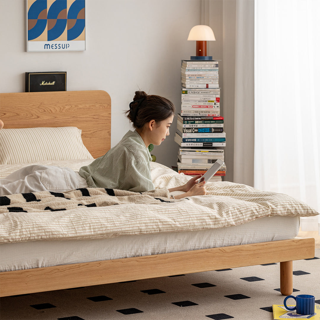 Scandinavian cherry wood bed isle in panoramic view.