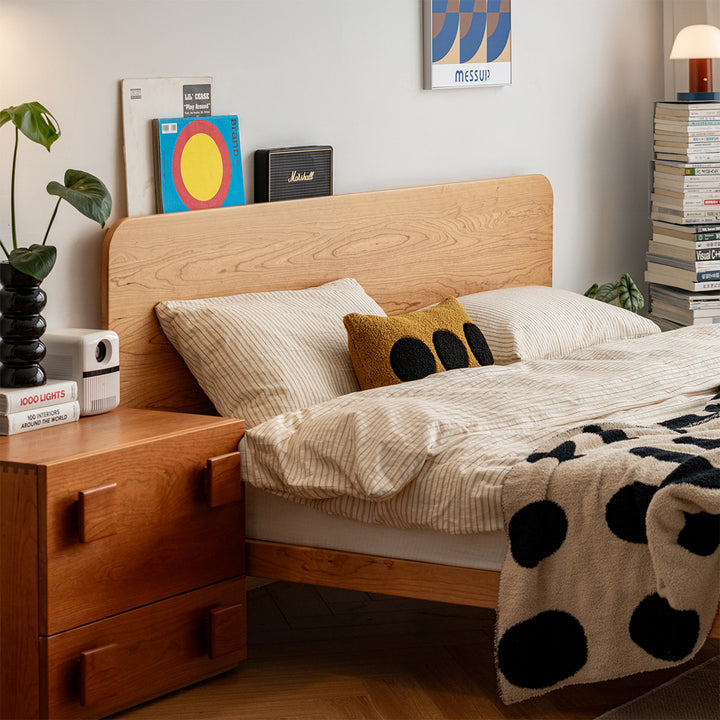 Scandinavian cherry wood bed isle in still life.
