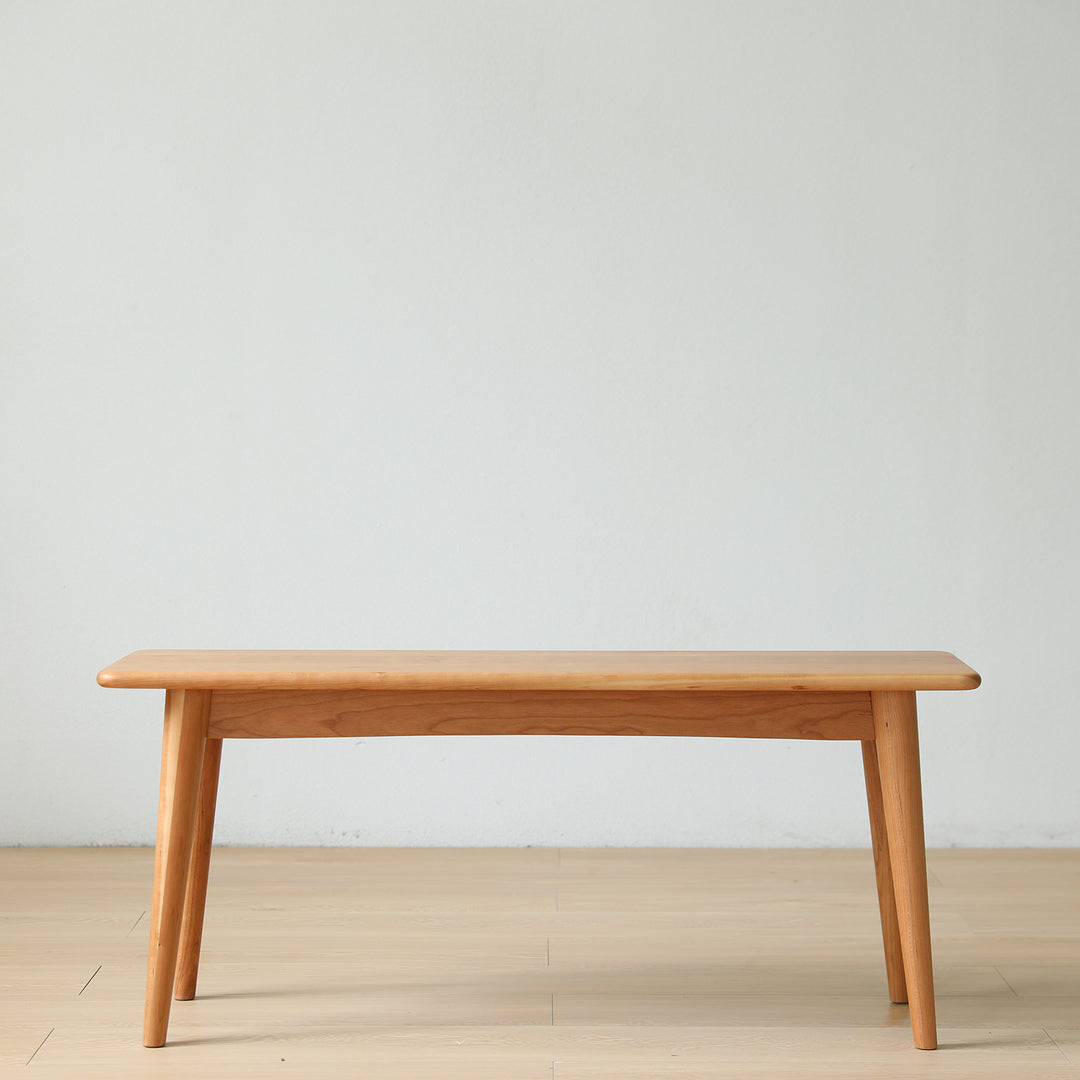 Scandinavian cherry wood dining bench green in panoramic view.