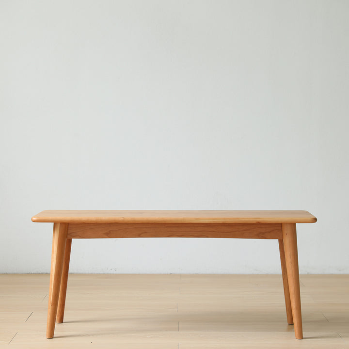 Scandinavian cherry wood dining bench green in panoramic view.