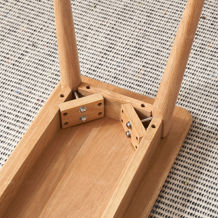 Scandinavian oak wood dining bench with cushion sereno in close up details.