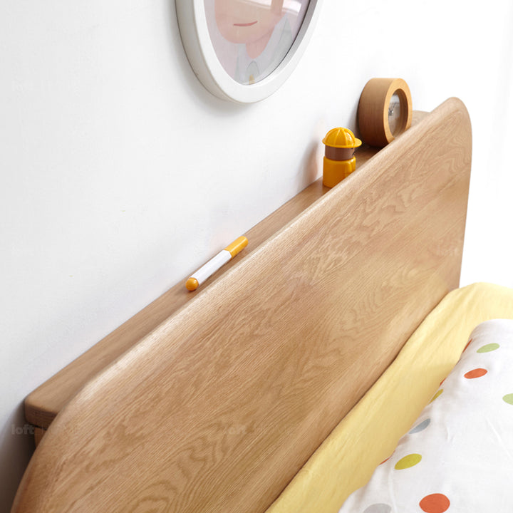 Scandinavian oak wood kids bed peblo in close up details.