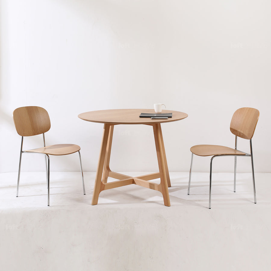 Scandinavian oak wood veneer round dining table orbit in white background.