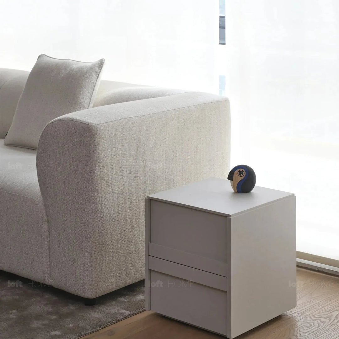 Minimalist fabric 3 seater sofa flower in close up details.