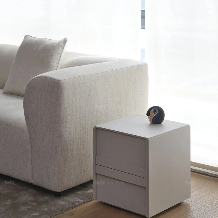 Minimalist fabric 3 seater sofa flower in close up details.