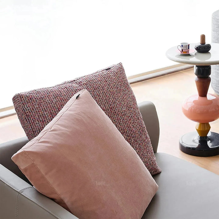 Modern fabric sofa pillow autumn pink in close up details.